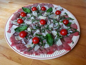 Carpaccio de bœuf, parmesan et basilic. 
<p>Finement tranché, ce carpaccio de bœuf est fondant à souhait grâce au contact prolongé avec sa marinade. Un plat authentique pour amateurs de viande crue.</p>
